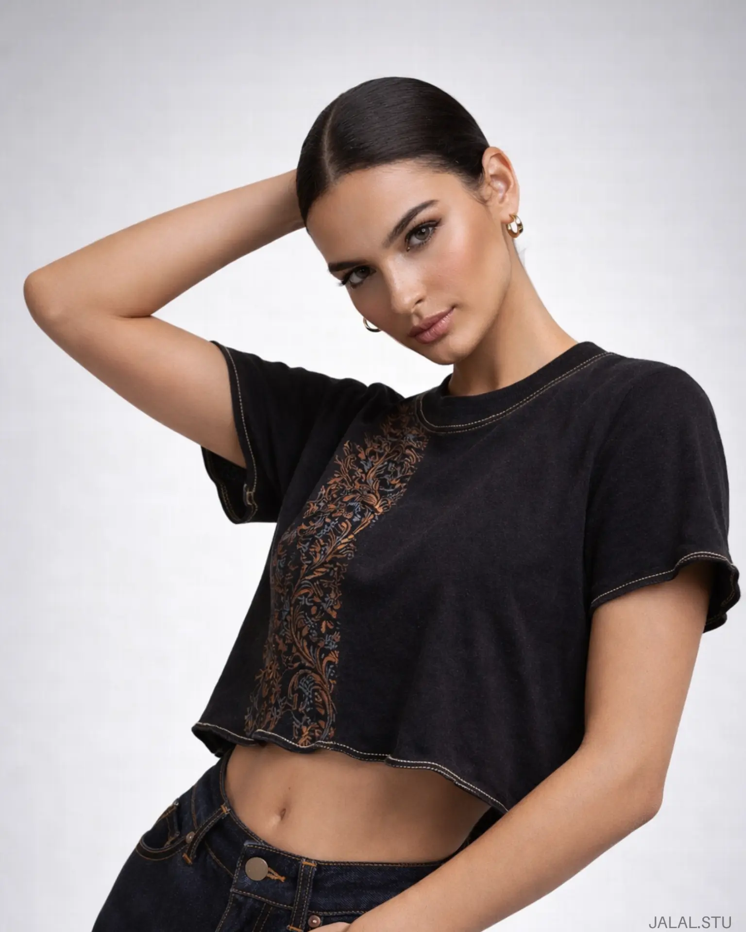 Campaign portrait — embroidered black crop top with raw-edge hem