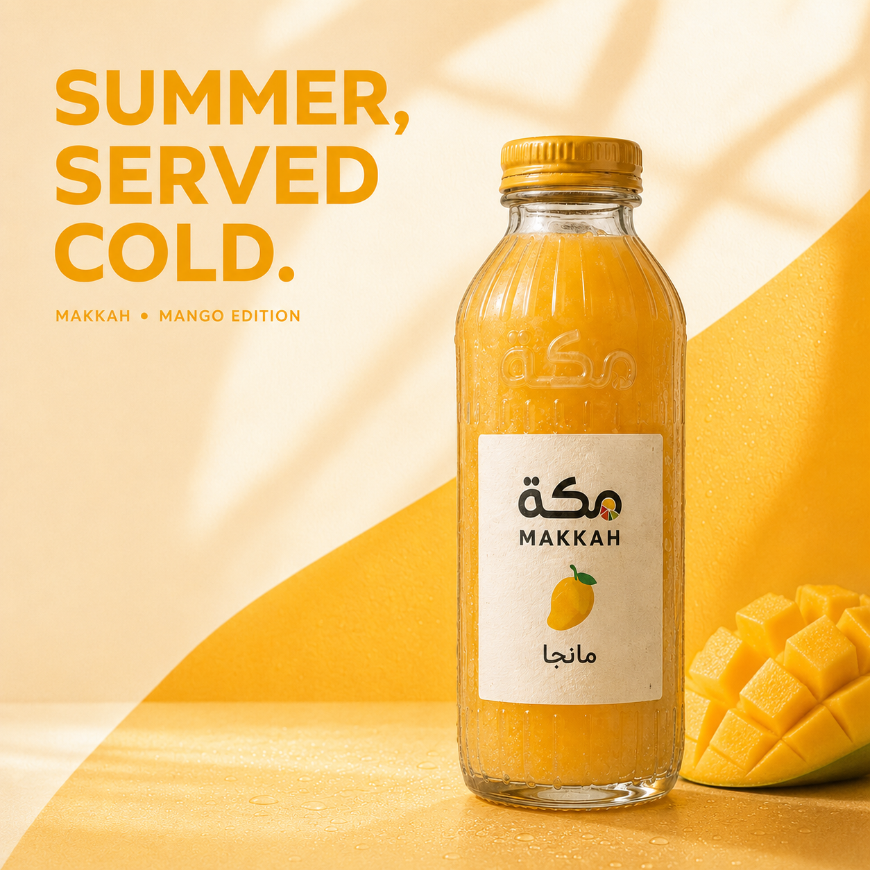 MAKKAH mango juice campaign key visual — glass bottle with mango and yellow studio backdrop