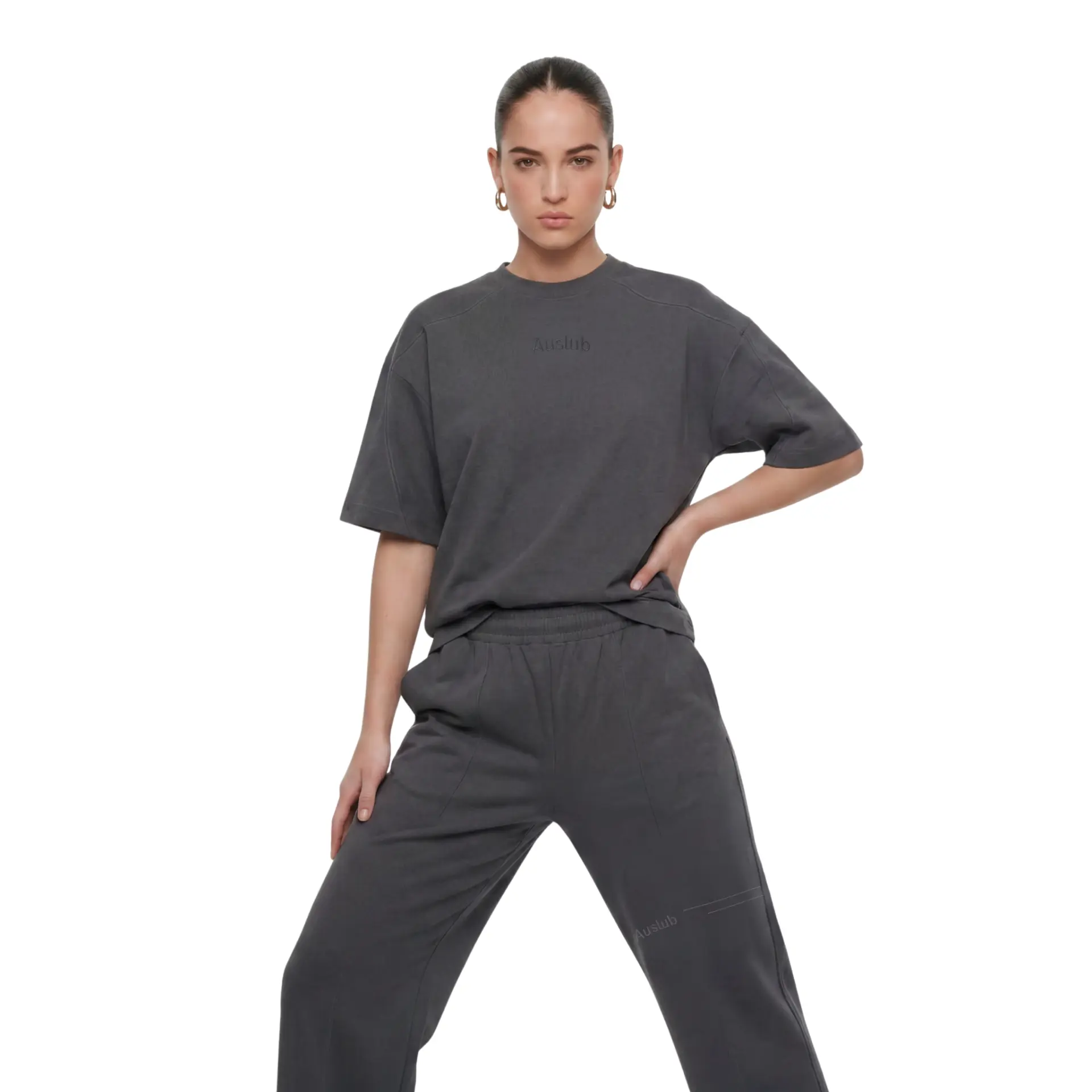 AUSLUB studio portrait — woman wearing a charcoal oversized tee and matching trousers